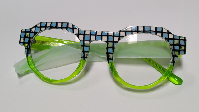 Green frames with light blue squares checkered with clear squares across the brow